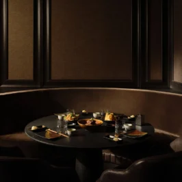 Interior of Oku Restaurant, featuring modern design with elegant lighting, wooden accents, and stylish dining tables set for a luxurious dining experience at Adare Manor.
