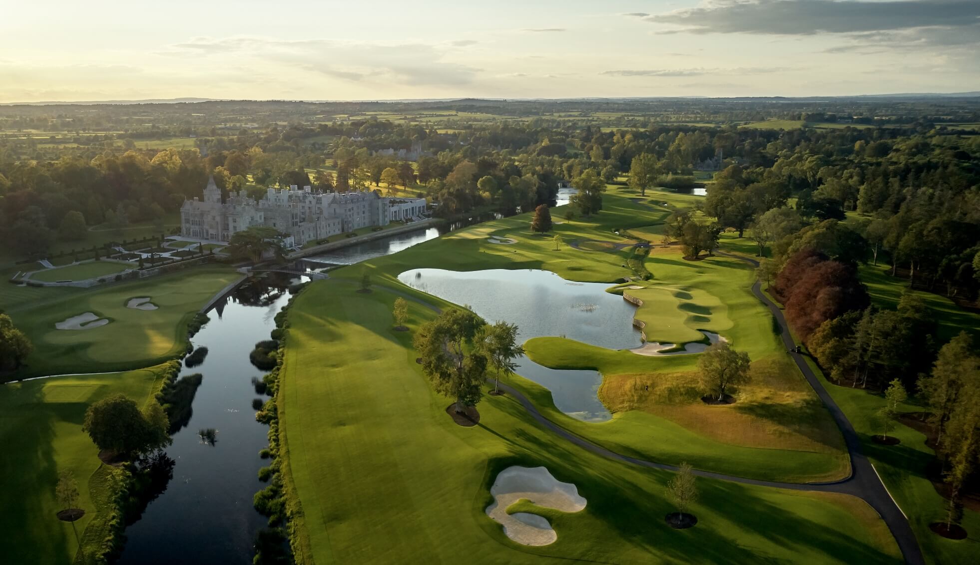 Aerial view of Adare Manor estate and championship golf course at sunset, Gothic Revival 5-star luxury resort in Adare, County Limerick, Ireland (spa, fine dining)